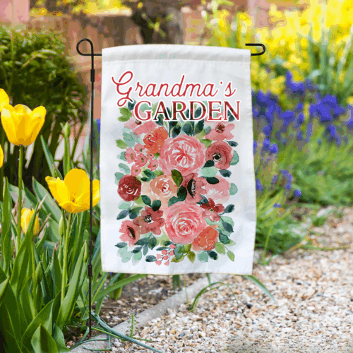 Garden flag in a flower bed with “Grandma’s Garden” floral design.